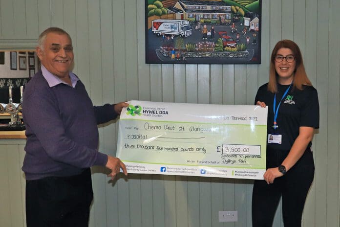 Ken Symonds presents a cheque of £3500 to Paige Denyer on behalf of the Chemo unit at Glangwili Hospital