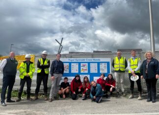 Carmarthenshire school competition winners see posters installed on building site