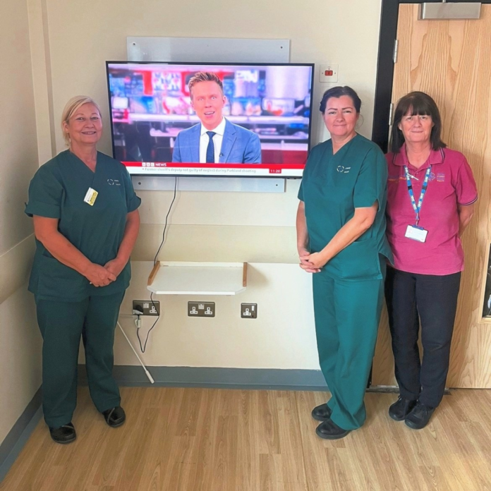 Staff-with-new-TVs.png