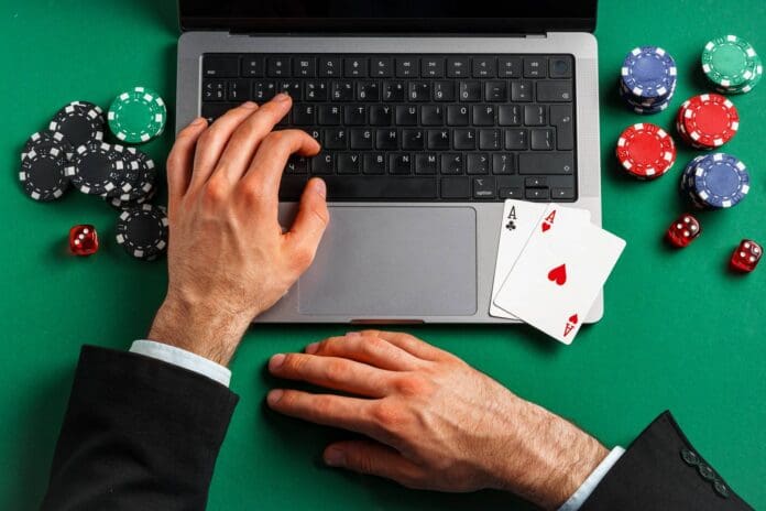 person-playing-online-poker-with-laptop-and-cards-2024-08-30-21-15-33-utc_wp